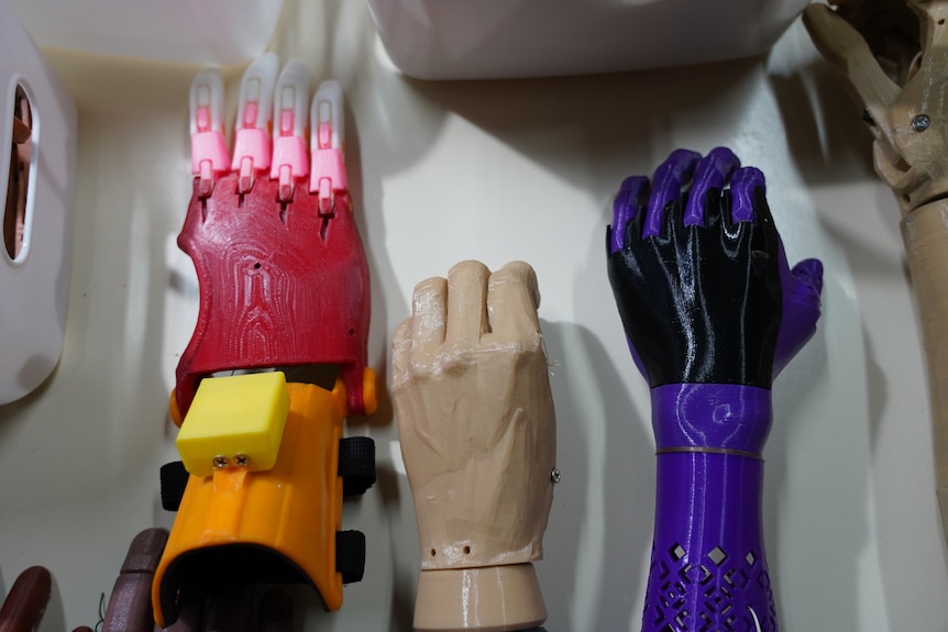 A row of prosthetic arms in bright colours