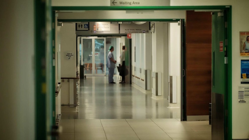 Hospital corridor with two medical staff standing in the distance at Mackay Base Hospital.