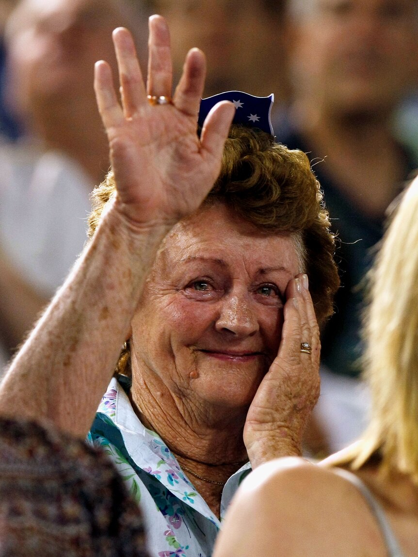 Casey Dellacqua's grandmother wipes away tears and offers a little wave after Dellacqua wins a game at the Aus Open