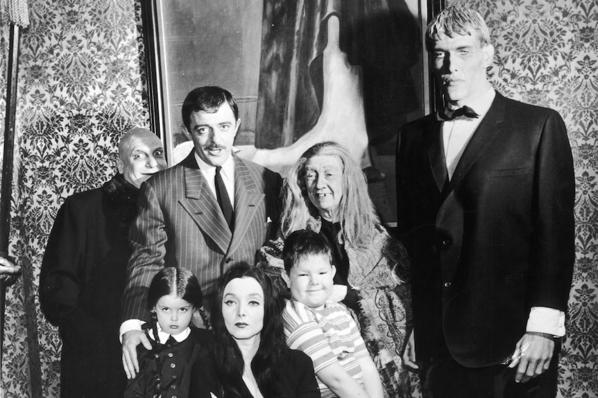 A black and white photo of the casts of the 60s TV series The Addams Family