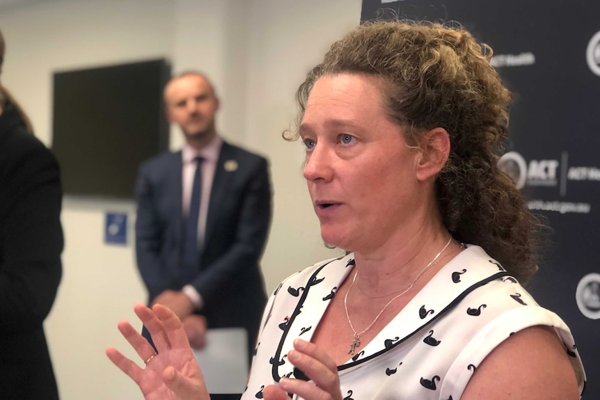 Kerryn Coleman speaks to the media while Chief Minister Andrew Barr looks on.