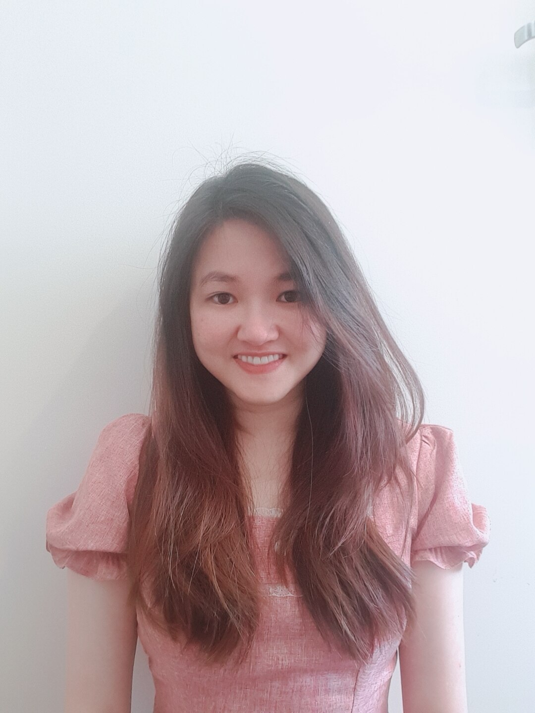 A woman smiles in a professional portrait