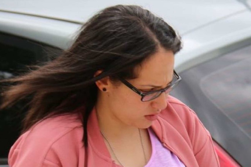 Lydia Abdelmalek looks down as she walks down a footpath outside court.