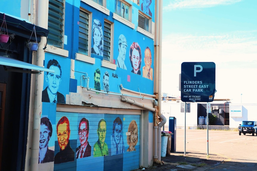 collection of images painted on a blue wall