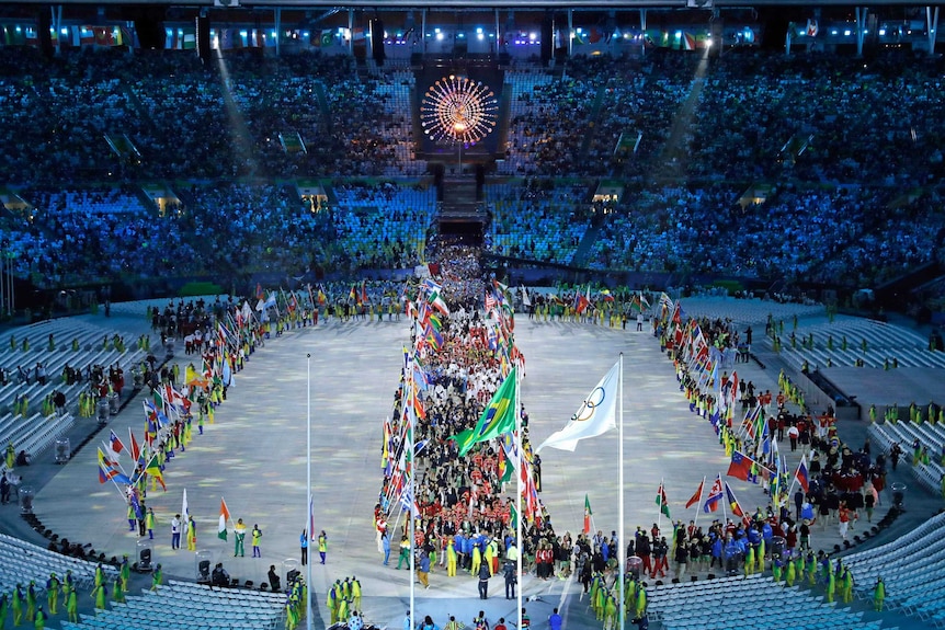 A parade of athletes enters the closing ceremony in the Maracana stadium.