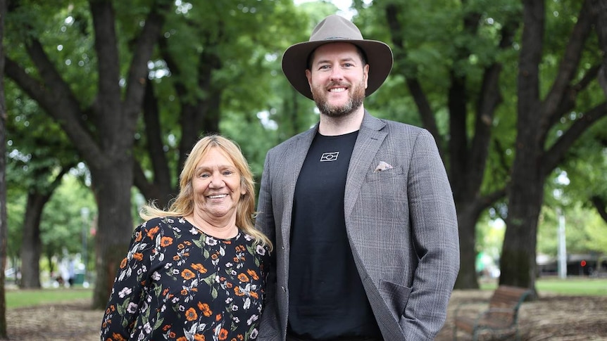 Geraldine Atkinson and Marcus Stewart stand side-by-side in a park.