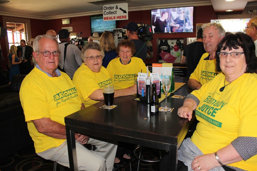A group of older Australians in bright yellow Barnaby Joyce supporter t-shirts.