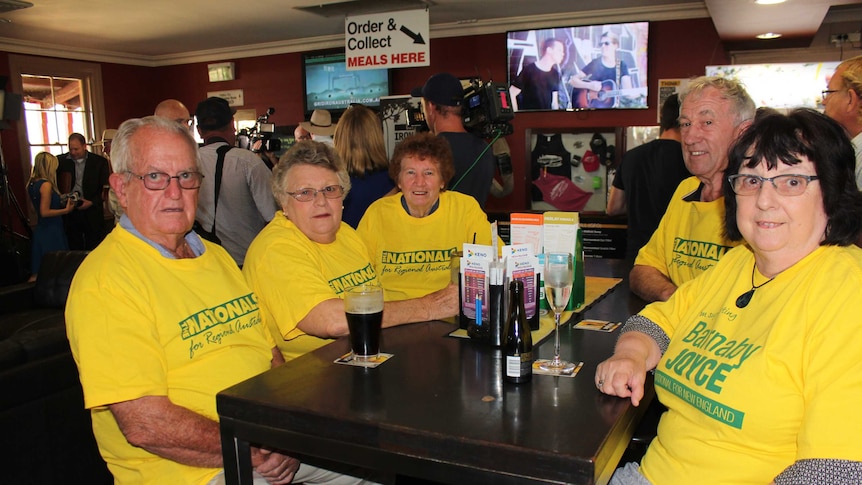 A group of older Australians in bright yellow Barnaby Joyce supporter t-shirts.