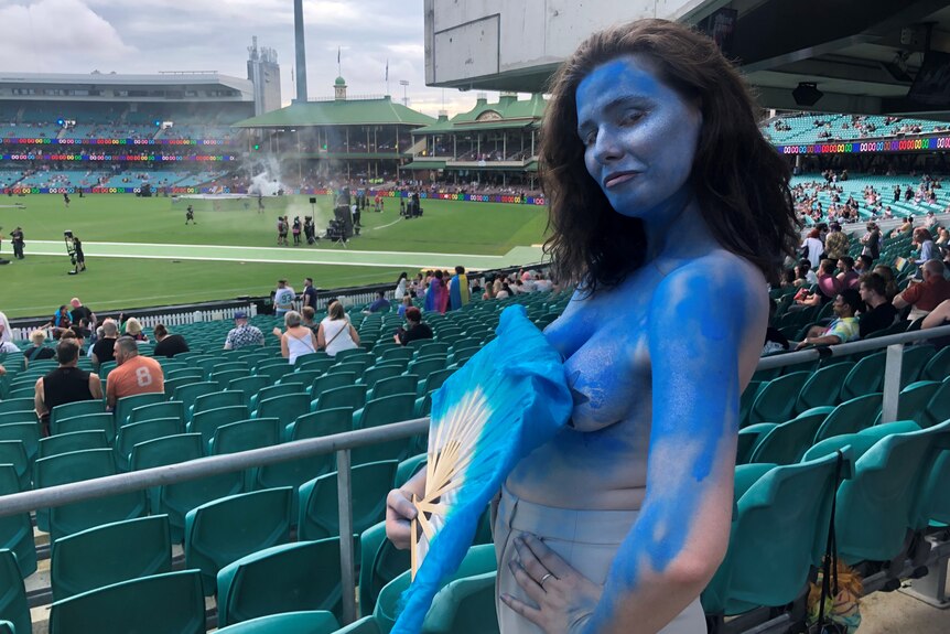 a woman with a fan painted blue