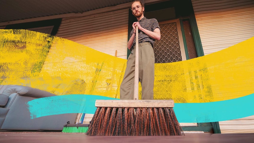 Man standing on his front porch holding a broom for a story about unexpected benefits of cleaning and gardening.