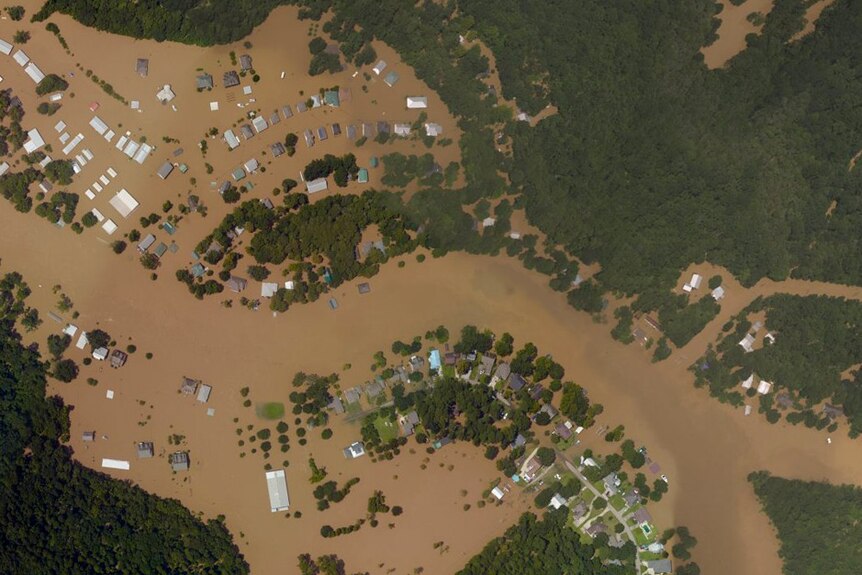 Satellite imagery shows homes in Port Vincent, Louisiana, submerged by floodwaters.