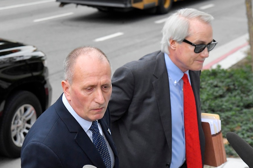 British cave expert Vernon Unsworth arrives at court in a suit.