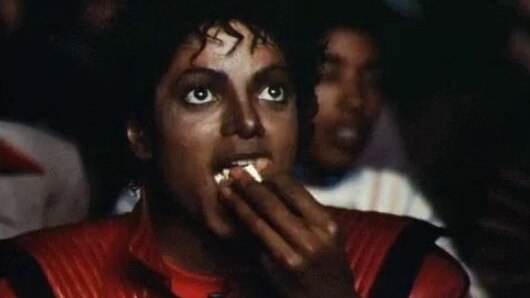 A still shows Michael Jackson eating popcorn.