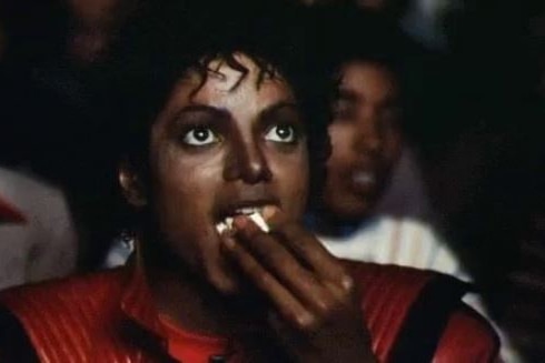 A still shows Michael Jackson eating popcorn.