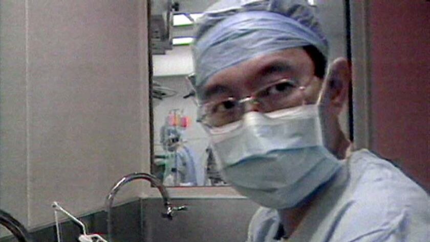 Renowned heart surgeon Victor Chang prepares for an operation