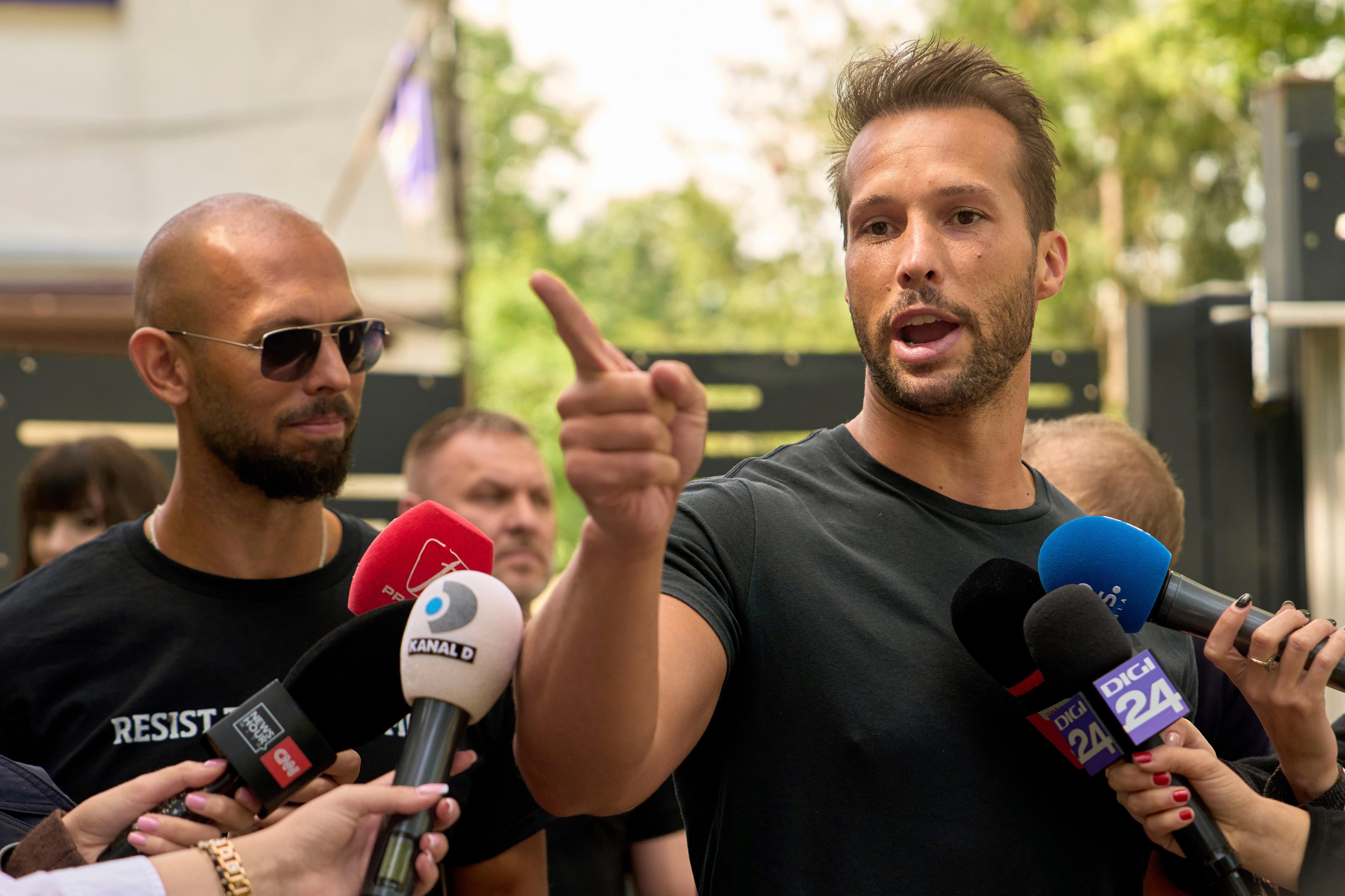 Why the Tate brothers were arrested and what they are charged with