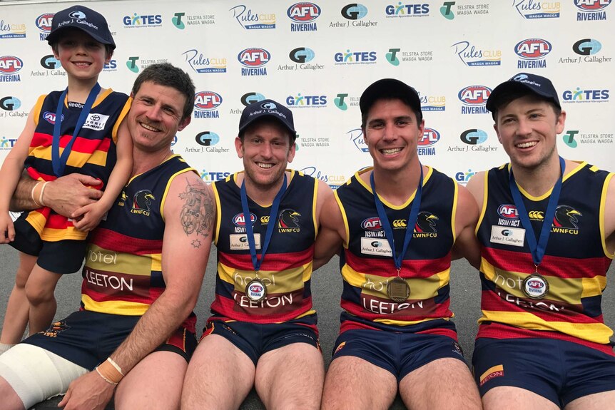 Leeton Whitton teammates smiling after winning the 2017 AFl Riverina premiership