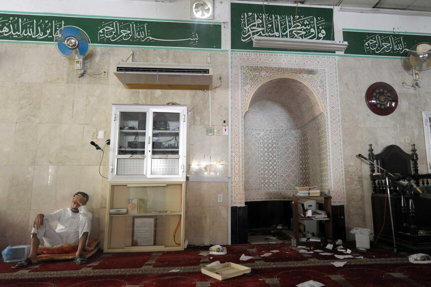 Man sits inside mosque after blast