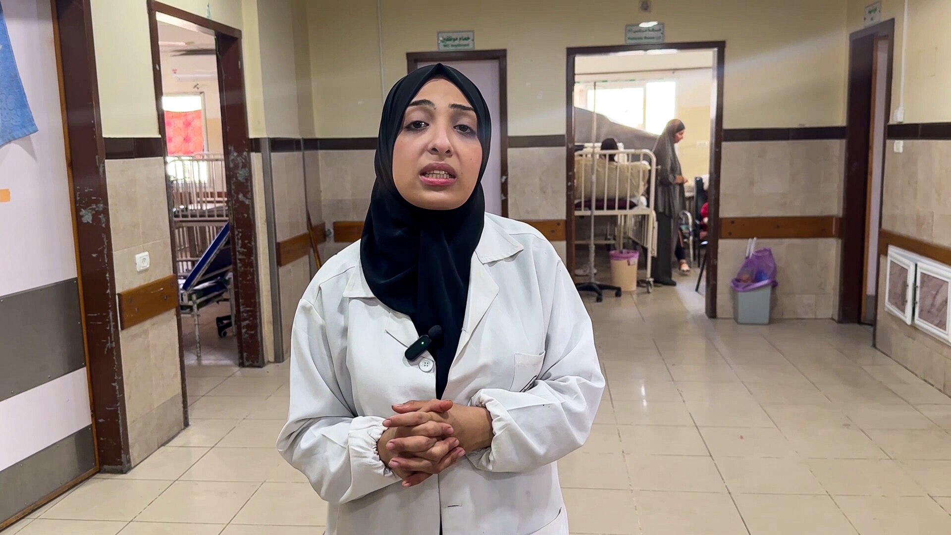 Nurse Nour Al-Tarabish stands in a hallway of the Kamal Adwan hospital.
