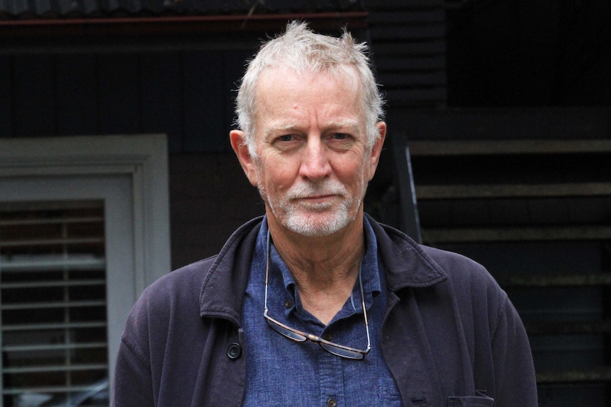 Peter Giutronich wears a blue shirt and blue jacket.