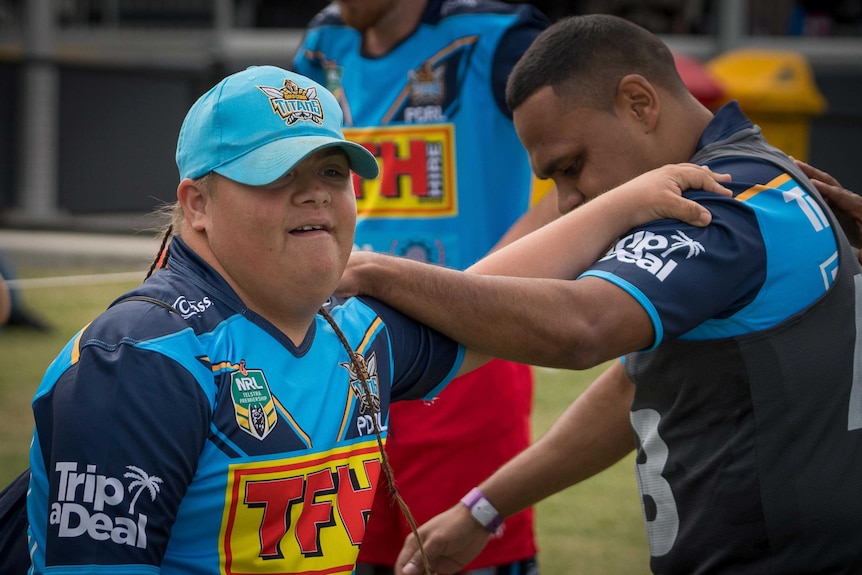 Physical disabilty player 'Warrior' Glew does some warm up exercises with another team member