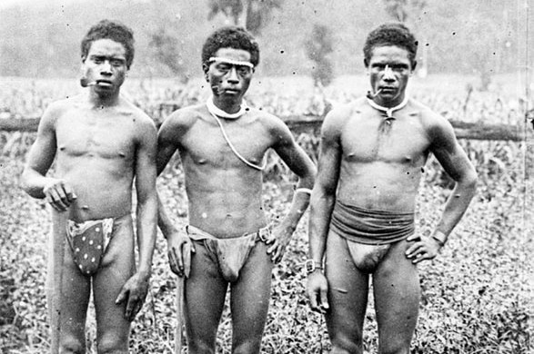 An archival image of South Sea Islanders who were blackbirded to Australia smoking a pipe on a sugar plantation.