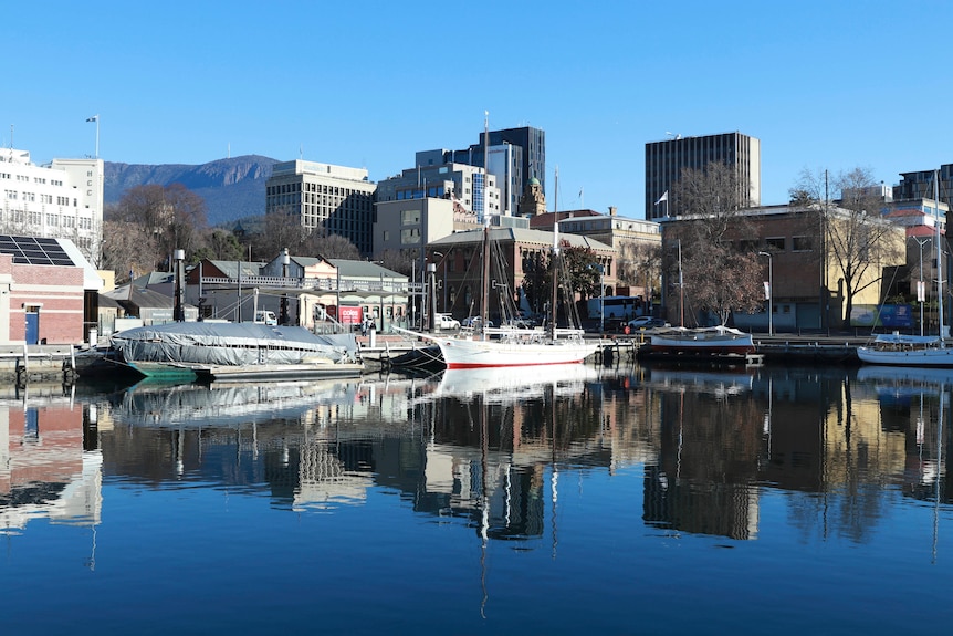 Mount Wellington and buildings reflected in water at Hobart docks.