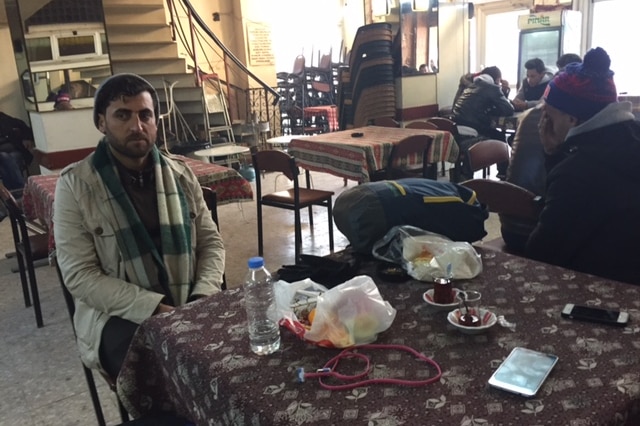 Two men sitting at a cafe.