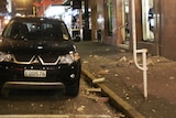 Concrete from a Featherston Street building facade came crashing down, narrowly missing a vehicle.