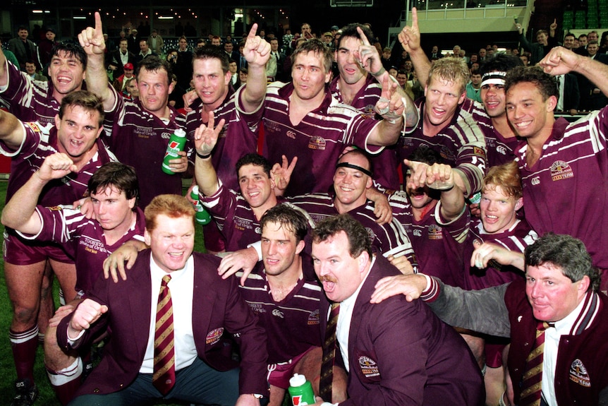 A group of rugby league players celebrate winning the State of Origin series