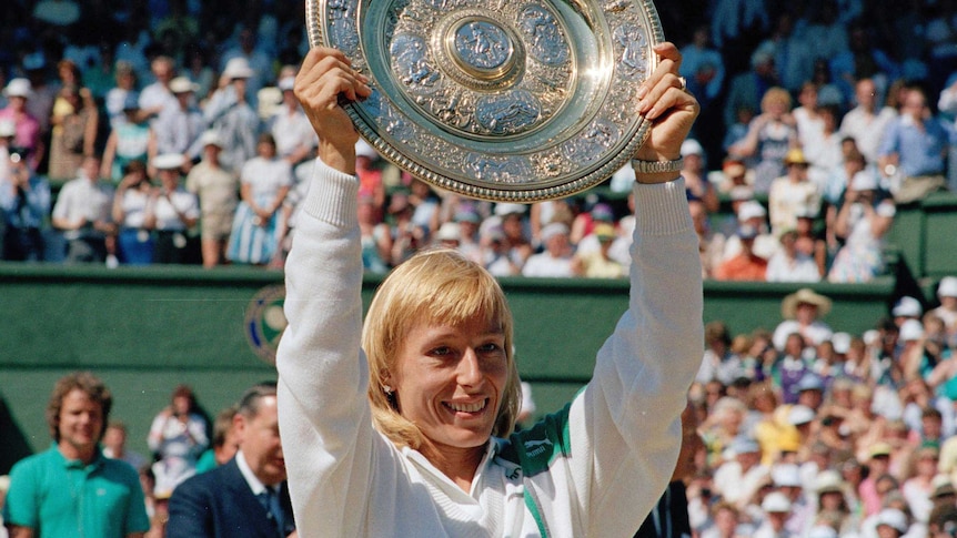 Martina Navratilova holds the trophy after winning the Wimbledon women's singles title