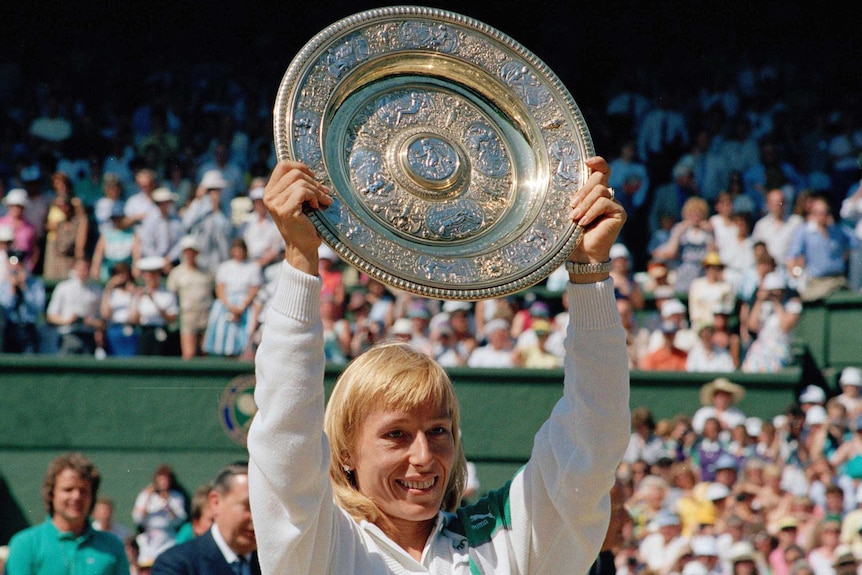 Martina Navratilova holds the trophy after winning the Wimbledon women's singles title