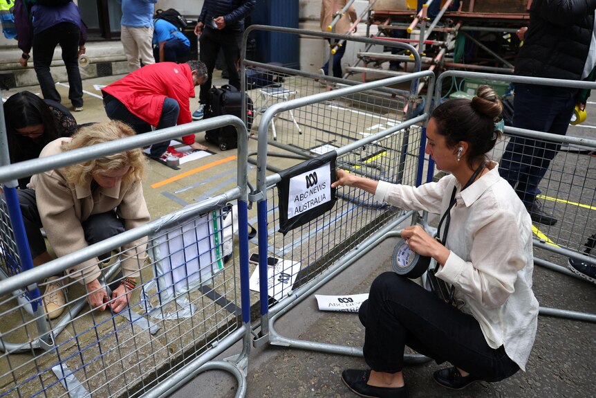 Media members mark up broadcast positions in a press area of Downing Street.