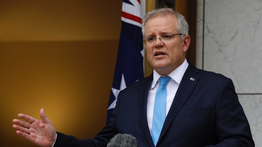 Scott Morrison addresses the media in a courtyard