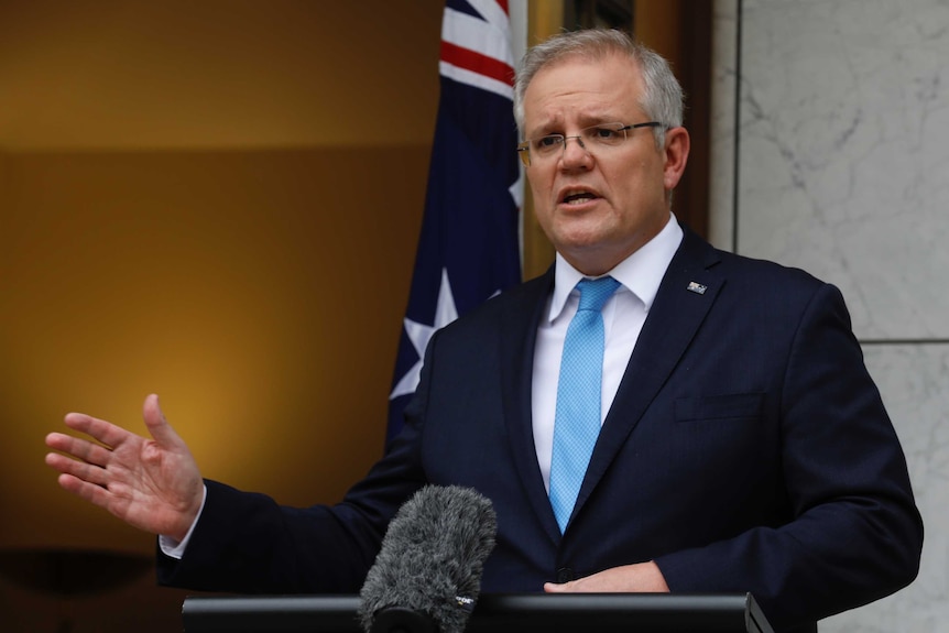 Scott Morrison addresses the media in a courtyard