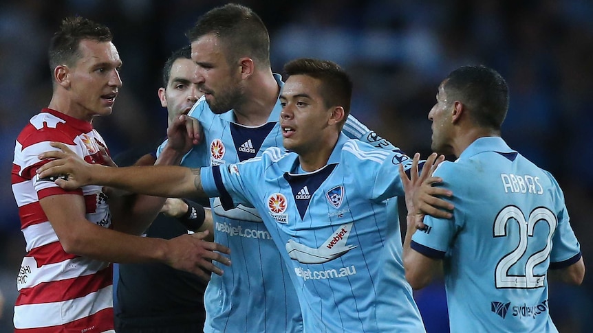 Hagi Gligor (C) calms down team-mate Ali Abbas of Sydney FC and the Wanderers' Brendon Santalab.