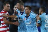 Hagi Gligor (C) calms down Sydney FC team-mate Ali Abbas and Brendon Santalab of the Wanderers.