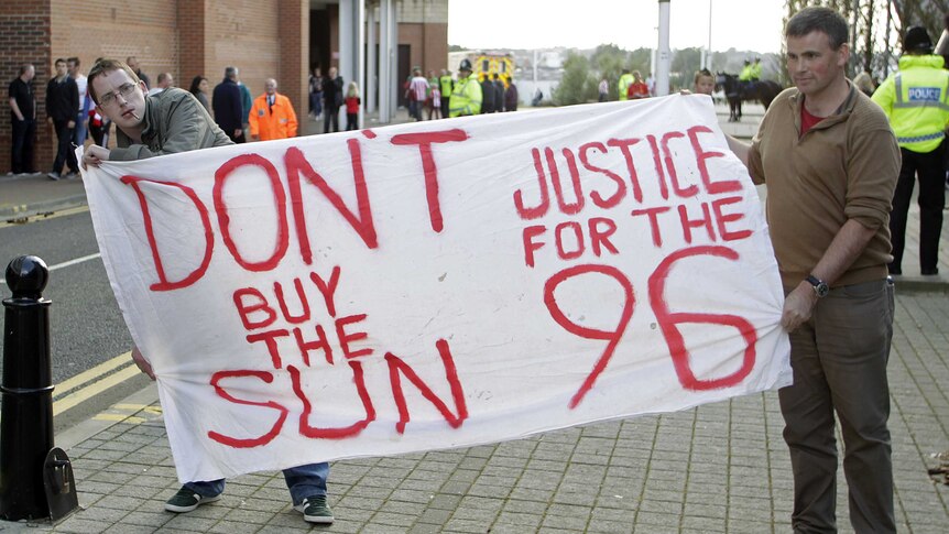 Liverpool supporters display a banner in support of the victims of the Hillsborough Stadium disaster.