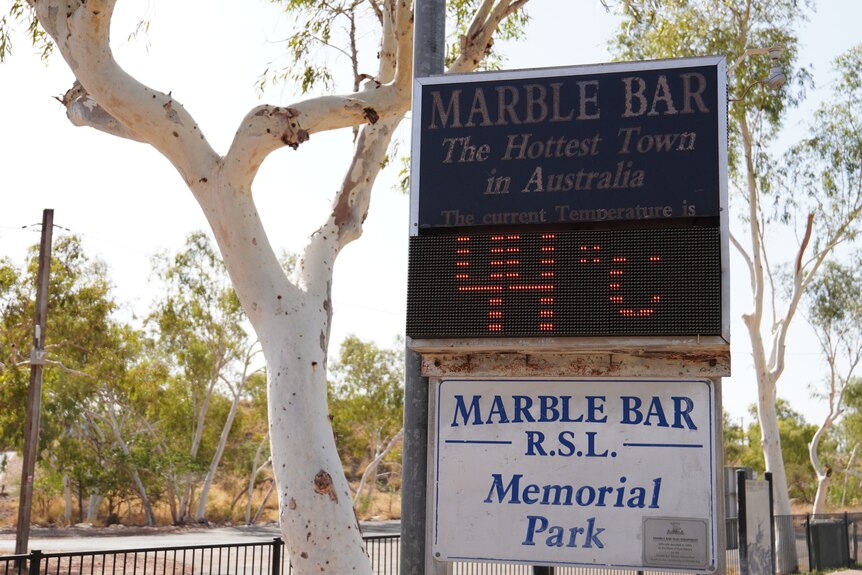 An electronic sign reads 44 C below a sign that reads "Marble Bar, the Hottest Town in Australia"
