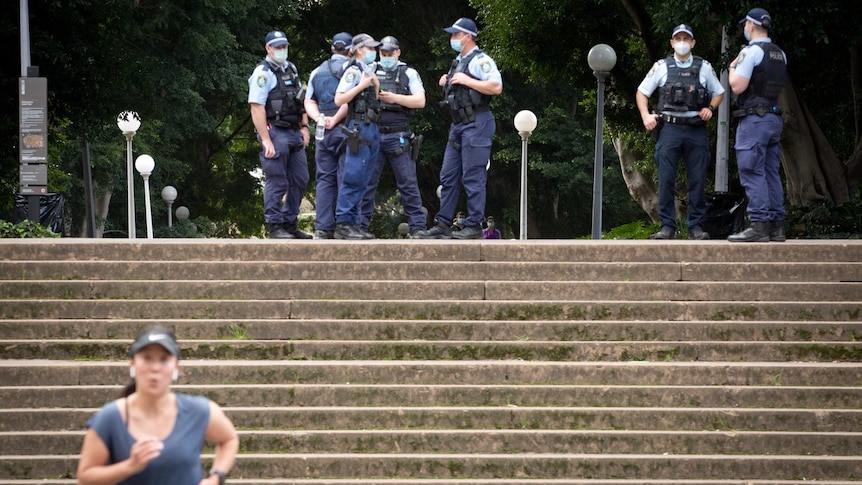 a group of police men standing on the top of stairs