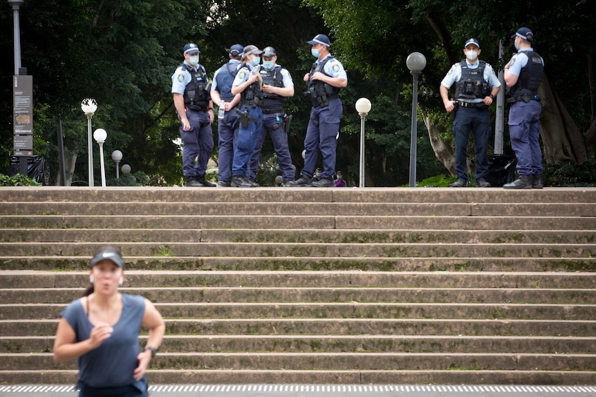 a group of police men standing on the top of stairs