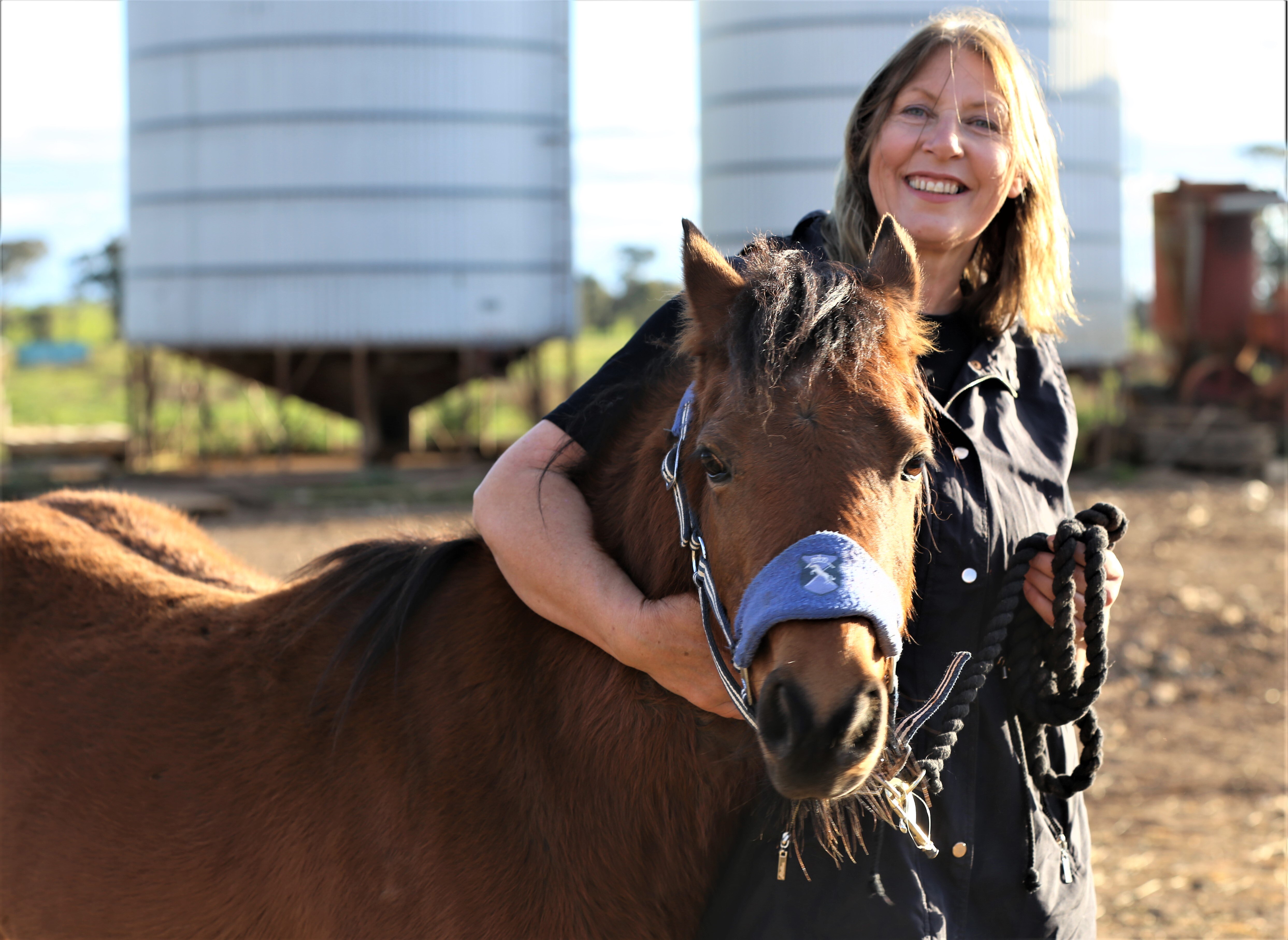 Photo of a woman and a horse.