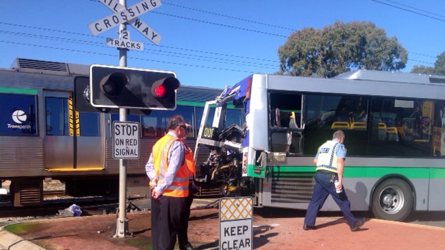 The back of a bus in ripped apart after a train hit it at a level crossing in Maddington, WA