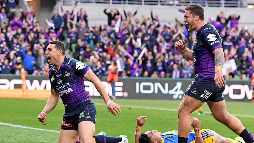 Billy Slater roars after scoring a try
