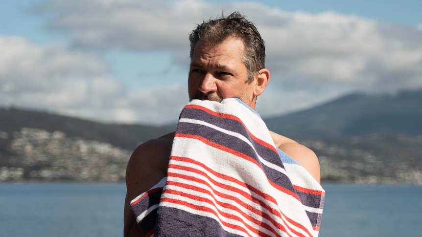 Simon Banks with a towel after swimming in the River Derwent.