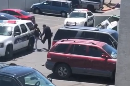 Screenshot shows police arresting man in carpark