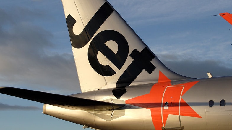The tail of a Jetstar aircraft showing its name an livery