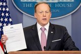 Sean Spicer holds up President Donald Trump's plan to repeal Obamacare