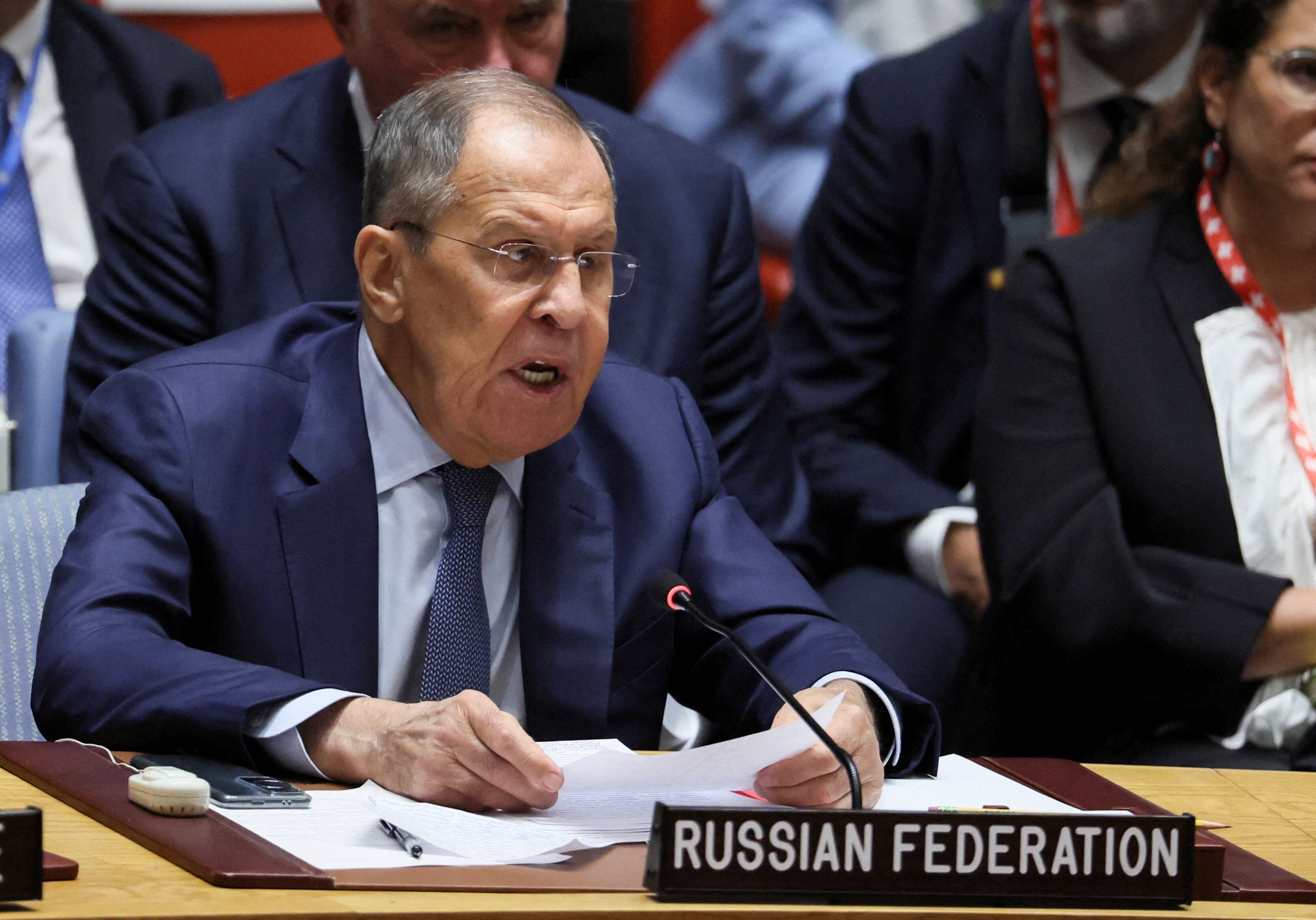 Sergei Lavrov sits behind a sign that says Russian Federation.