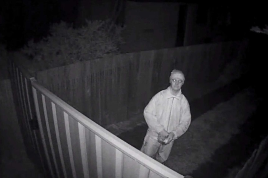 CCTV of a man trowing something over fence in Higgins.